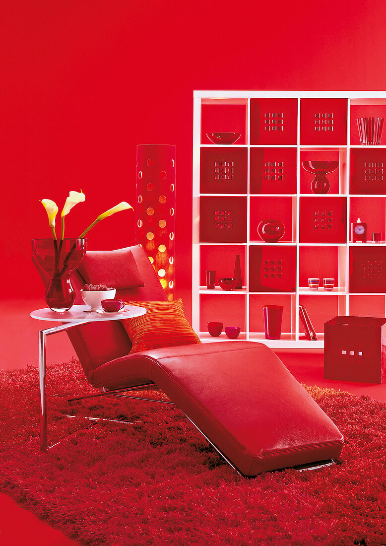 Red relaxing chair with vase and other decorations in living room
