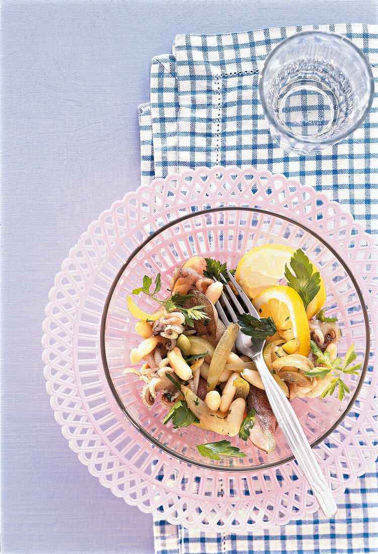 Octopus salad with lemon slice for crete diet in bowl