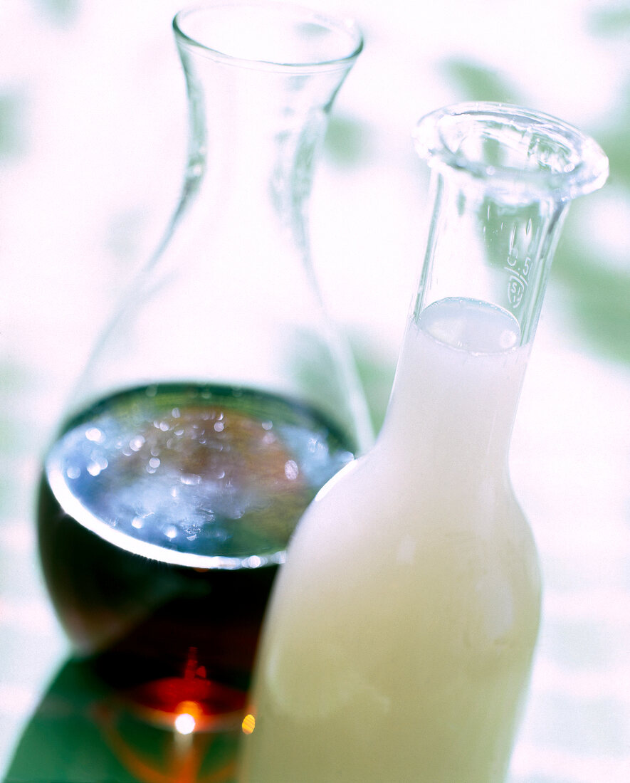 Close-up of bottle with almond syrup and flask with amaretto