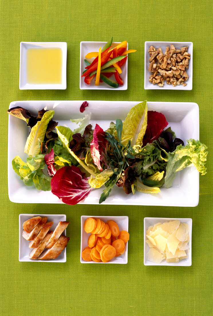 Salad compilation with extra virgin olive oil on plate, overhead view