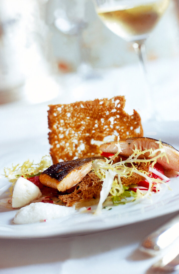Close-up of roasted arctic char with salad on plate