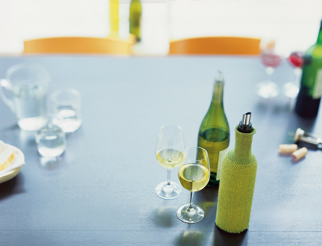 Wine glasses, bottles and water at home for wine testing