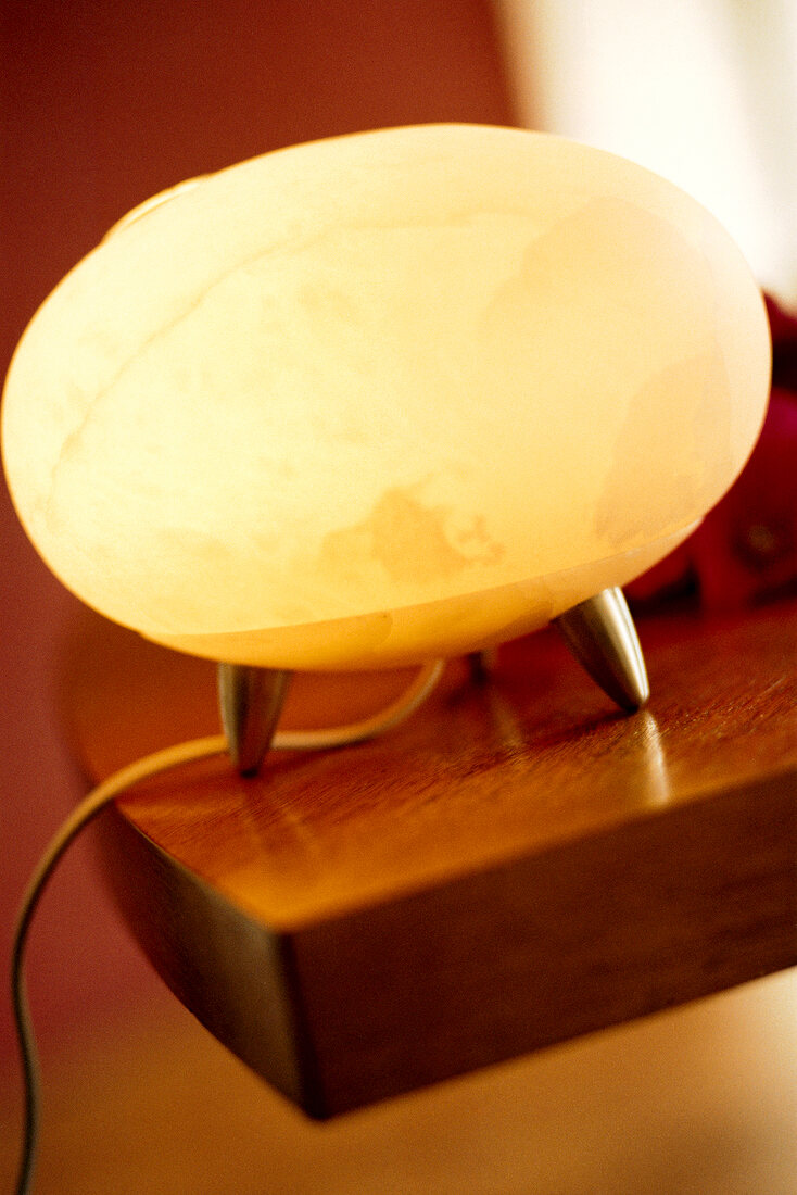 Close-up of glowing alabaster lamp with essential oils