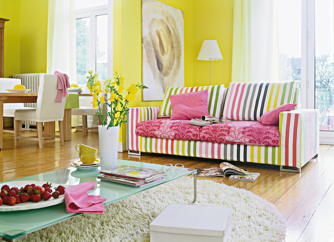 Striped upholstery sofa with coffee table and rug in living room