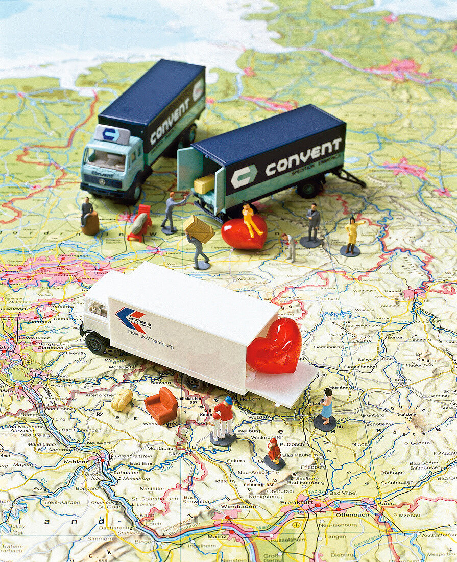 Toy cars and human figurines on land map depicting long distance relationship