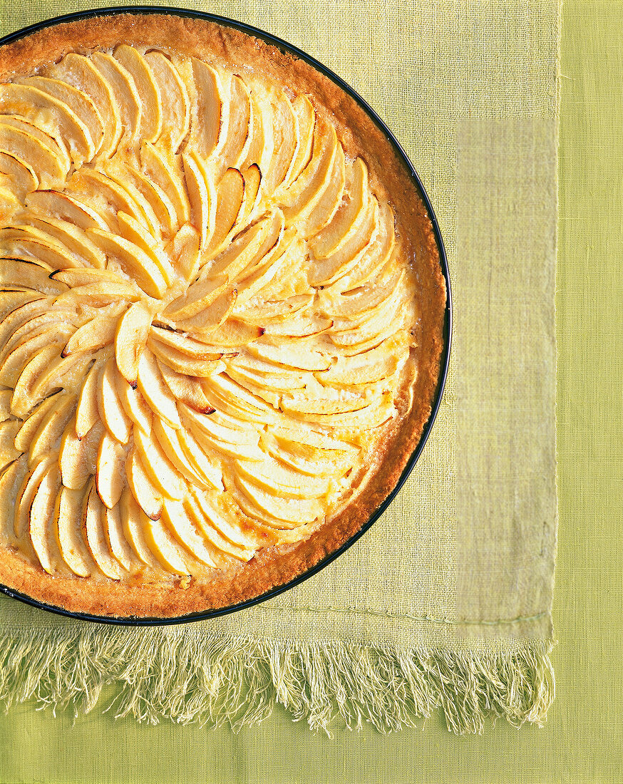 Close-up of French apple tart on green background