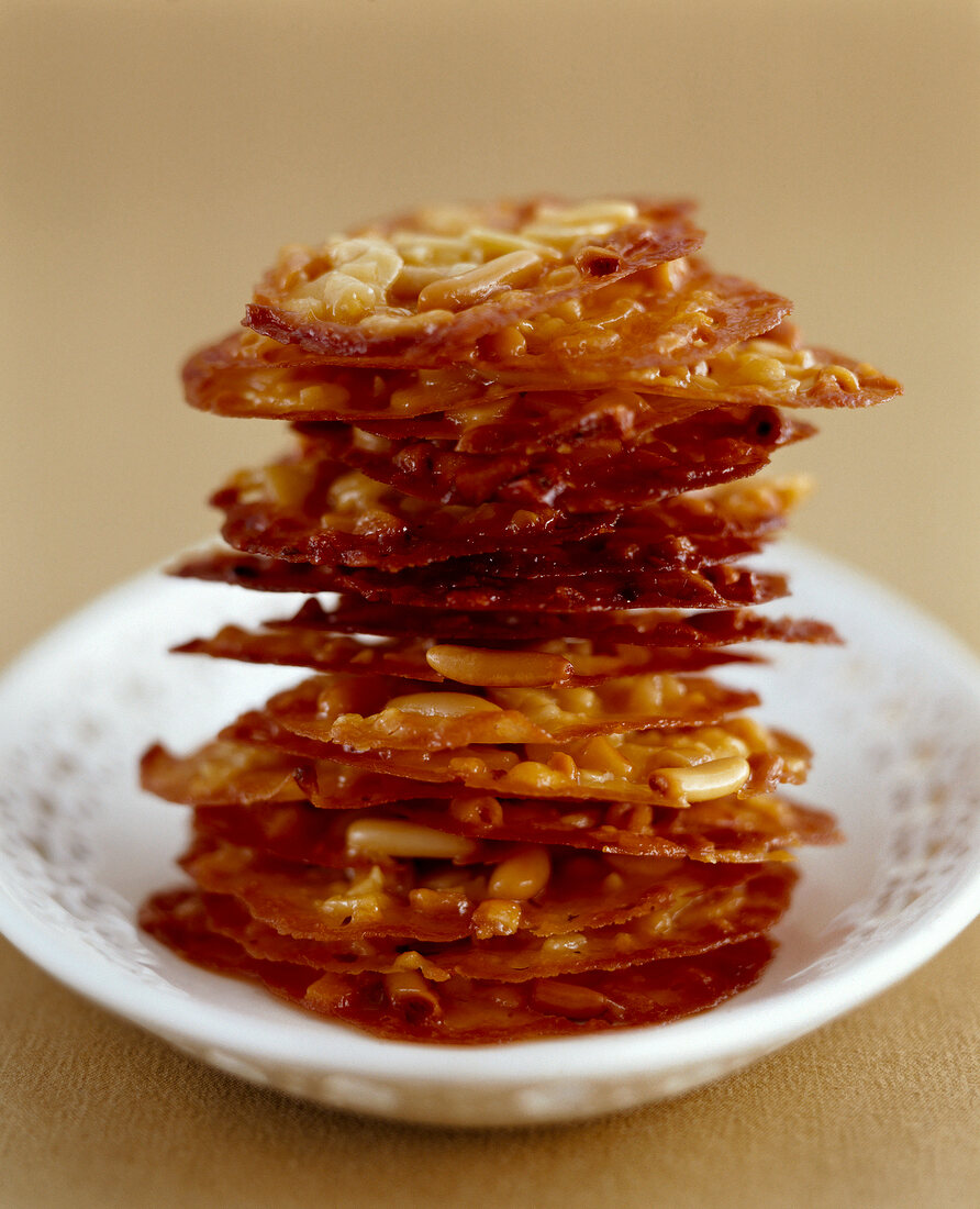 Honey florentines with fine almonds and pine nuts on plate