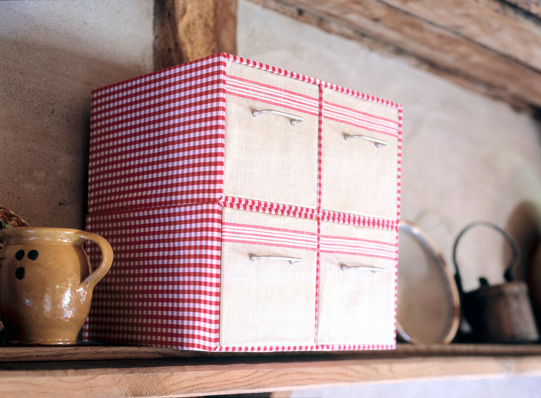Red and white checked mini chest on shelf
