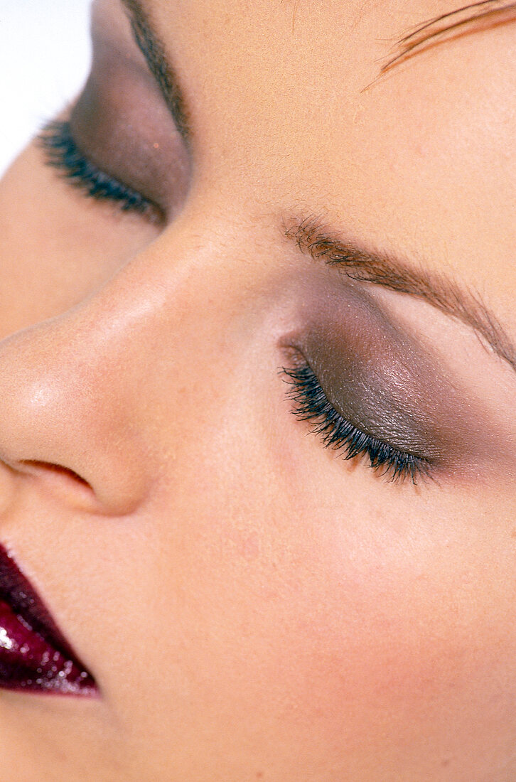 Close-up of woman's eye wearing eye shadow, eyes closed