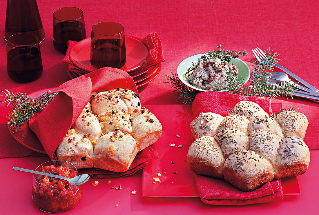 Fresh baked rolls with Christmas jam on red background