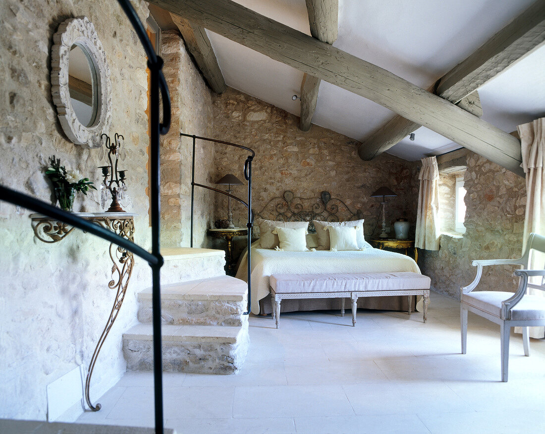 Bedroom with beamed ceiling and double bed in Provence, France