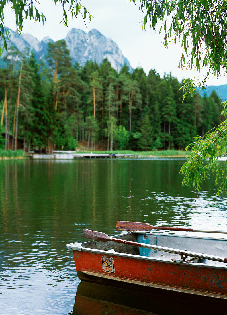 Rowing boat moored in idyllic lake at Vols, South Tyrol, Italy