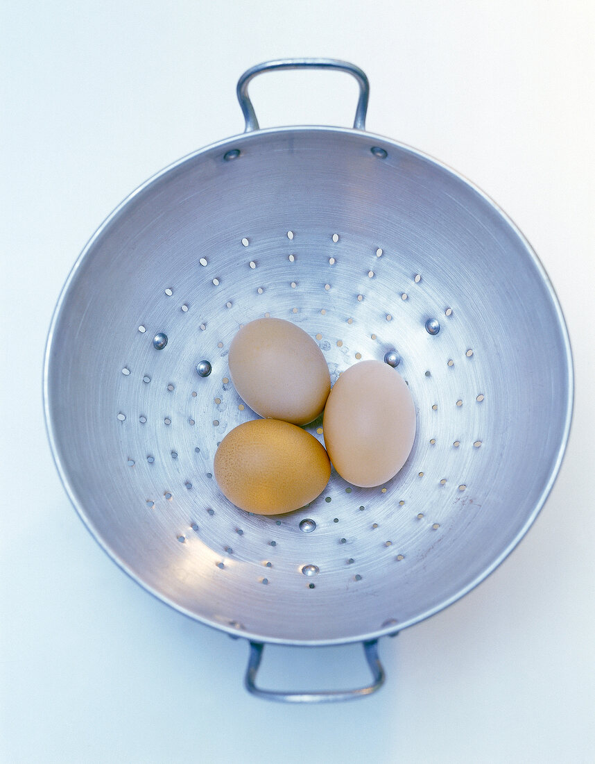 Brown eggs in colander