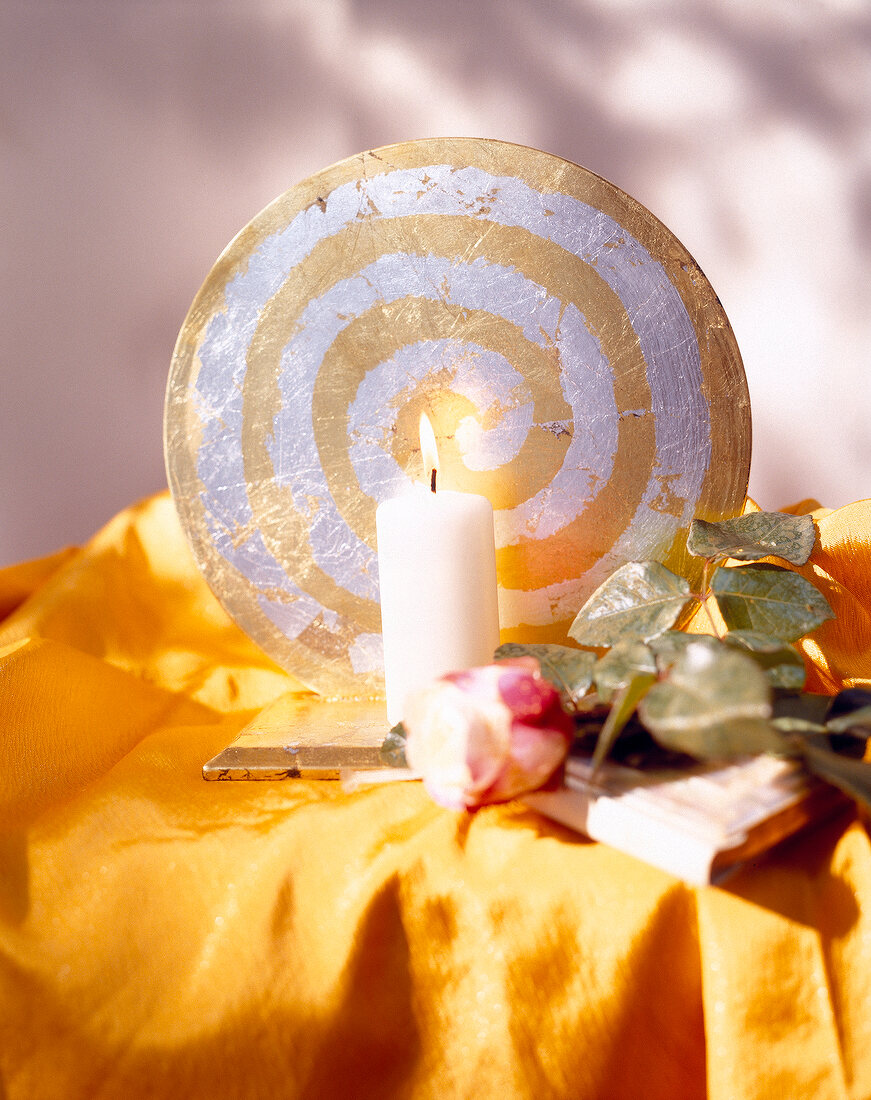 Gold and silver plated spiral candle holder with lit candle