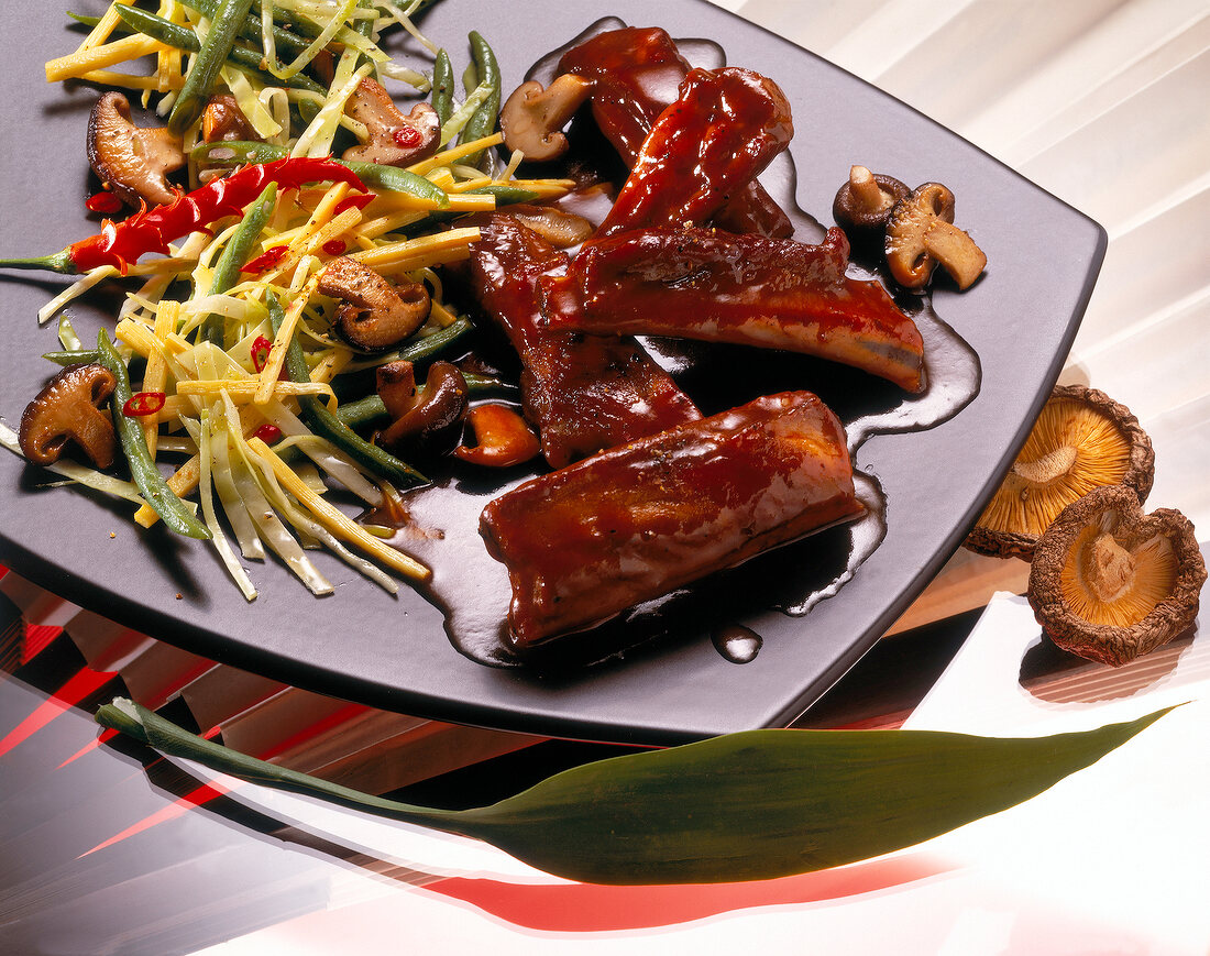 Braised spare ribs in Japanese rice wine on black plate, Euro-Asian cuisine