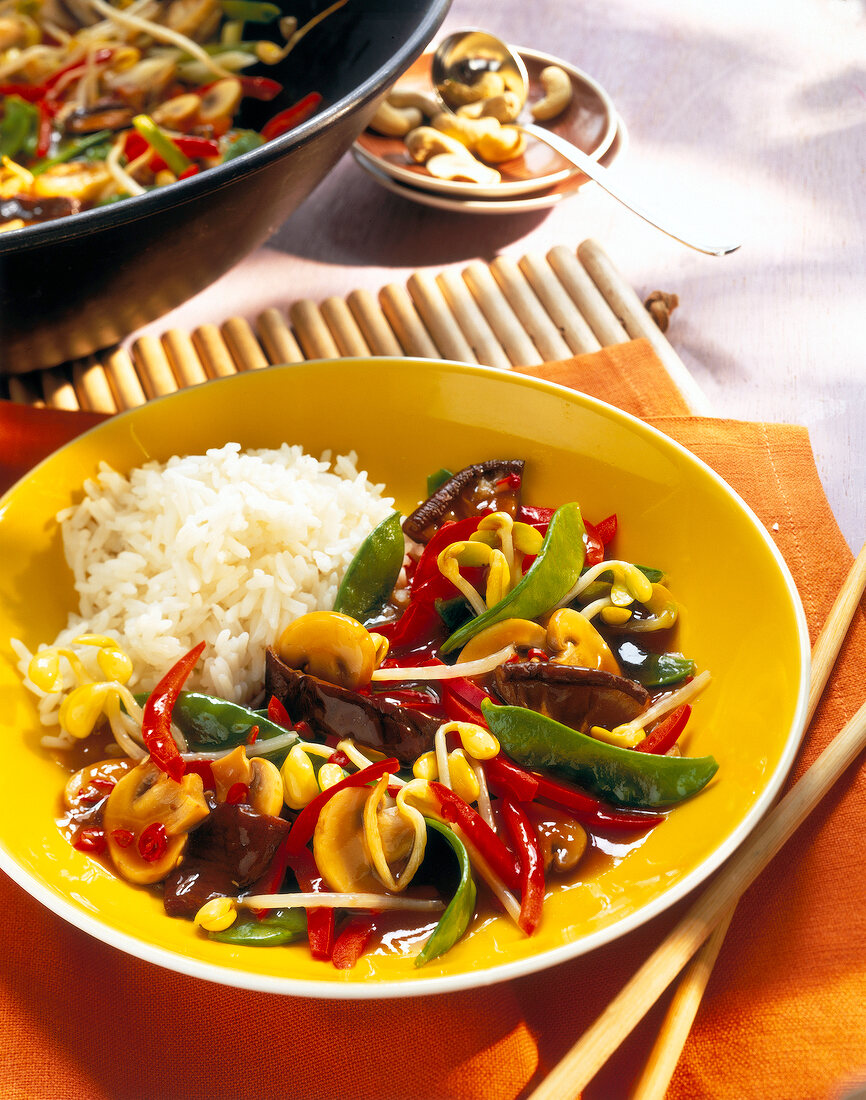 Fried vegetables with mushrooms and rice on plate