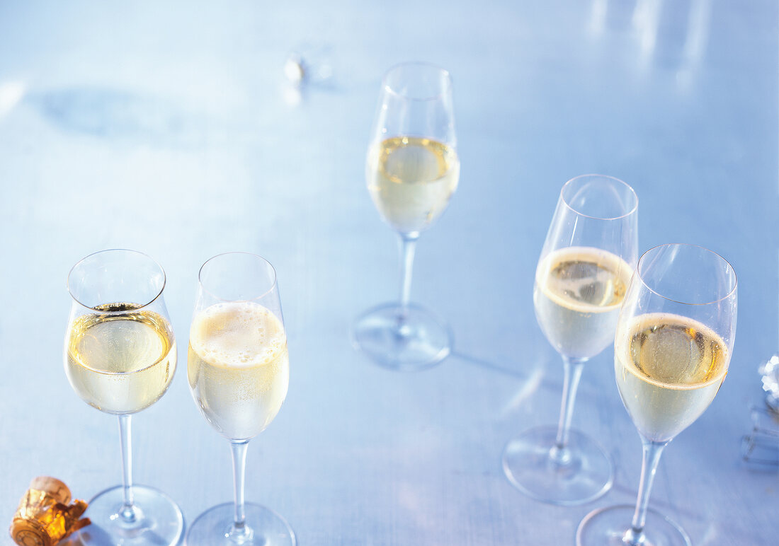 Champagne glasses filled with champagne on table