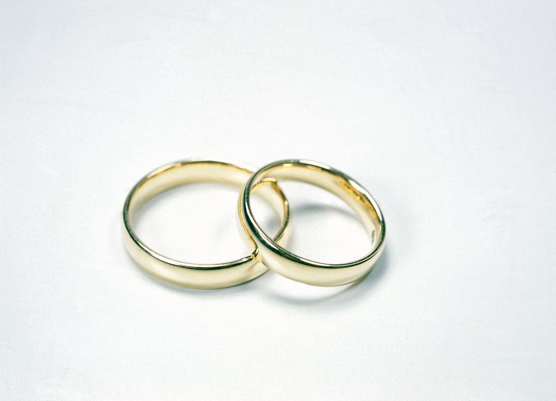Two gold ring on white background