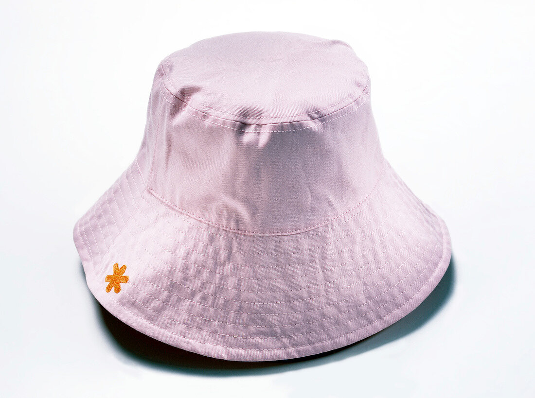 Pink floppy hat on white background