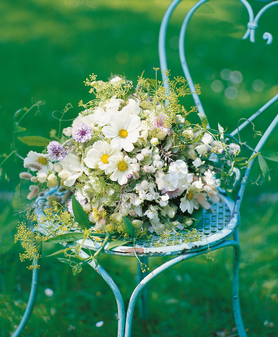 Bridal bouquet on chair in garden