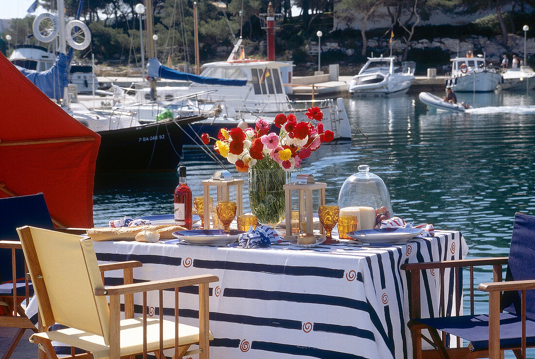 Laid table and moored boats in background at Maritim Hotel