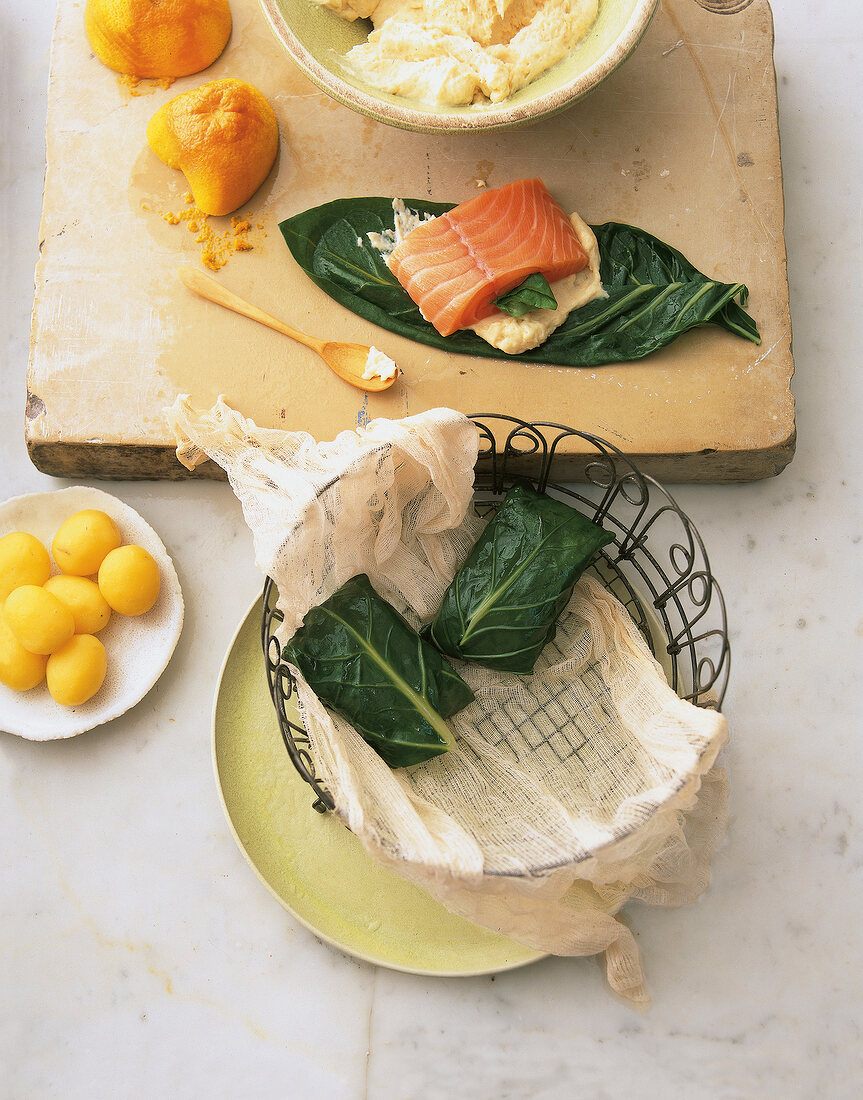 Swiss chard with salmon and potato filling on wooden sheet
