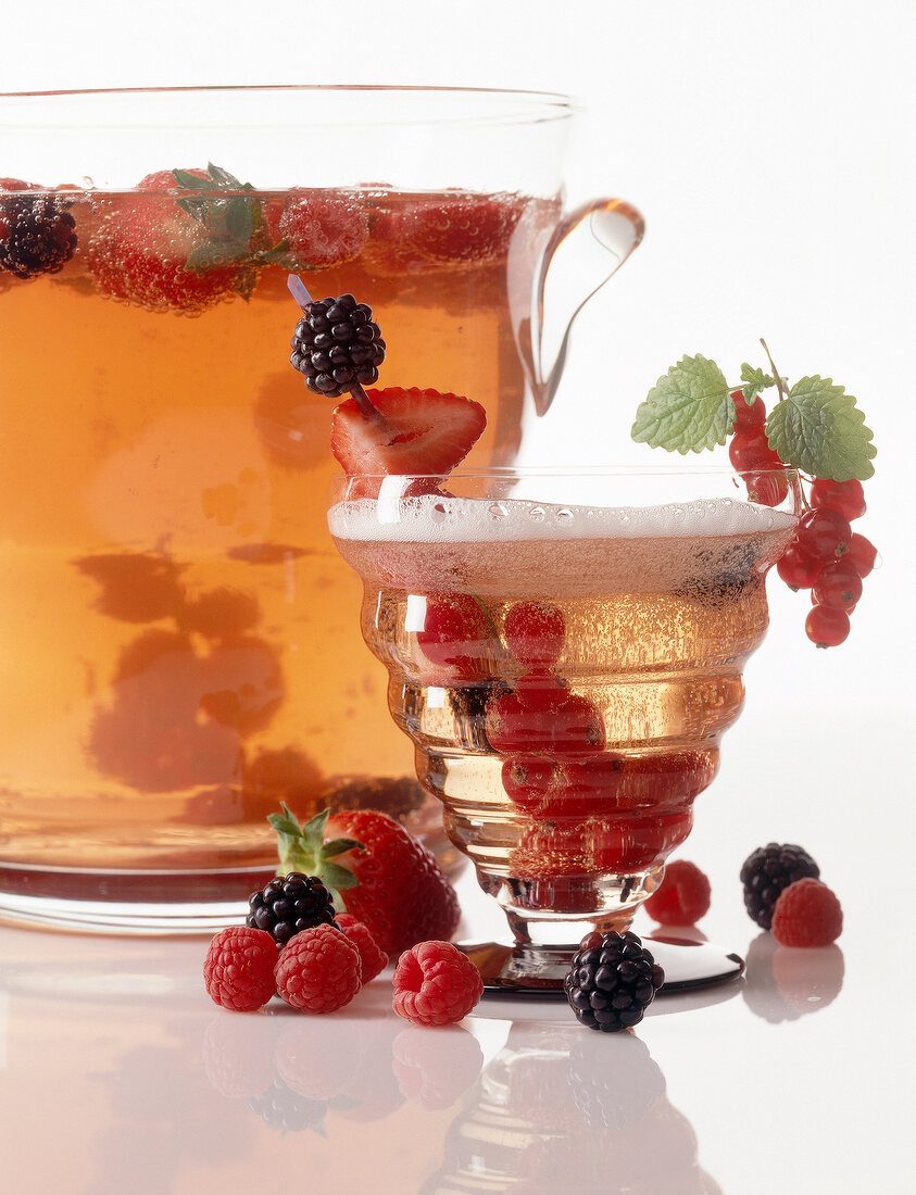 Berry punch with garnishing of various berries in glass