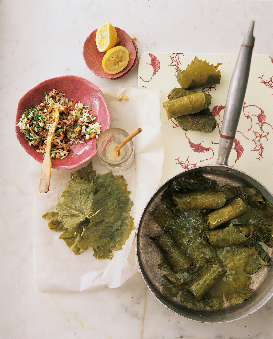 Grape leaves with lamb and rice in pan and bowl