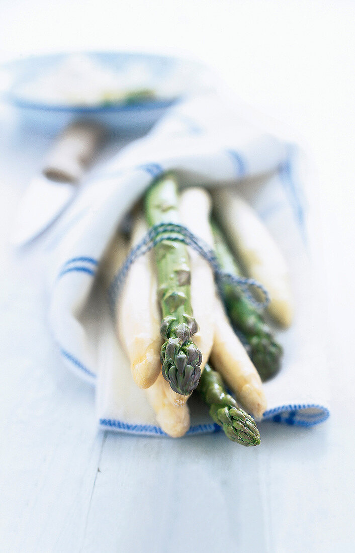 Close-up of bundles of asparagus wrapped in napkin