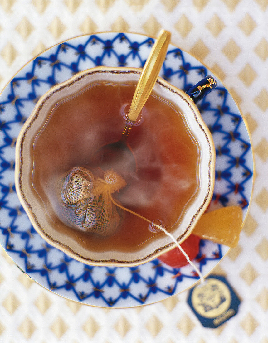 Cup of tea with tea bag and spoon, overhead view