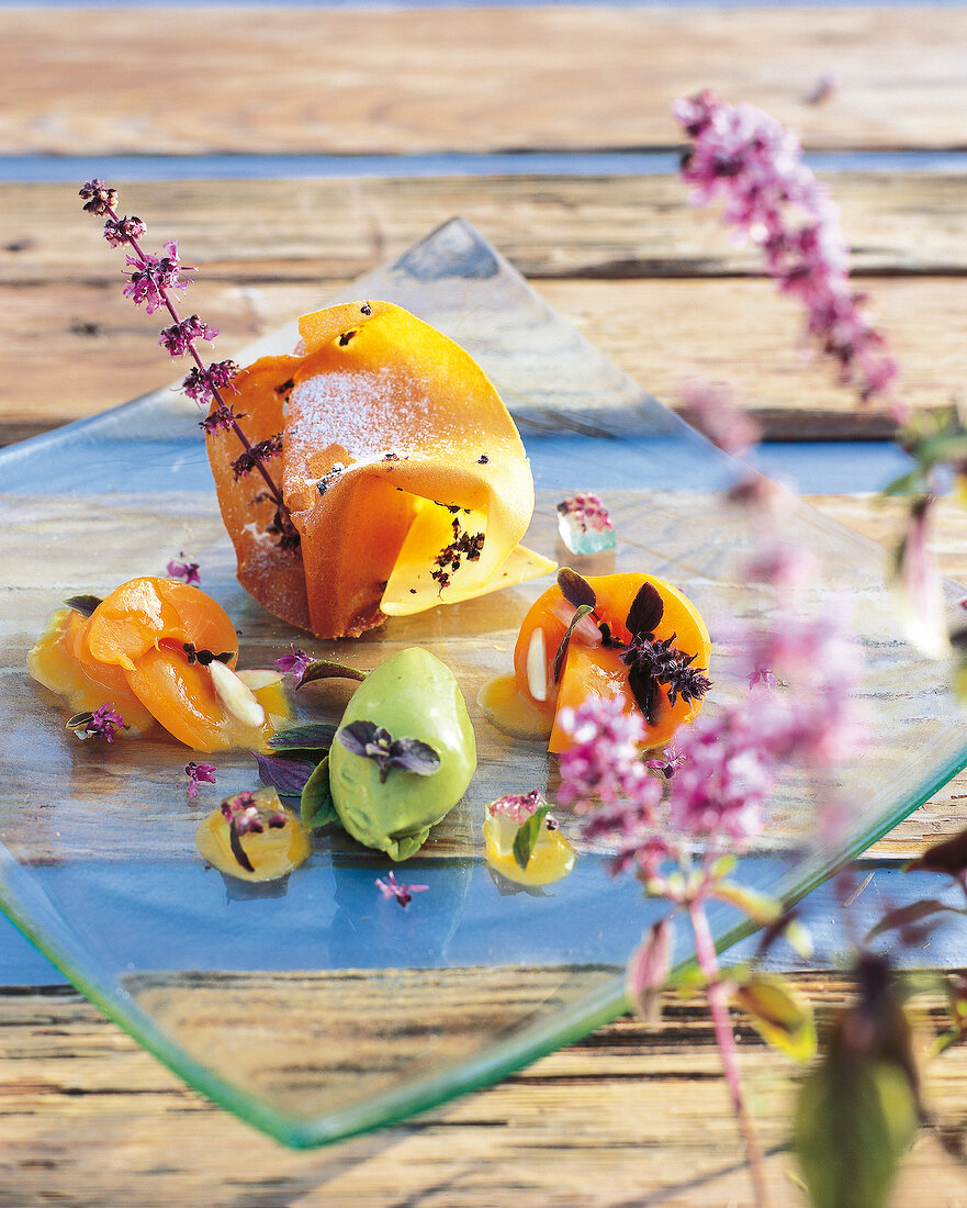 Apricot and basil on glass plate