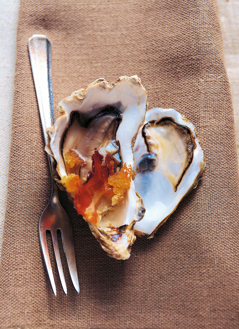 Oysters with bacon on brown cloth