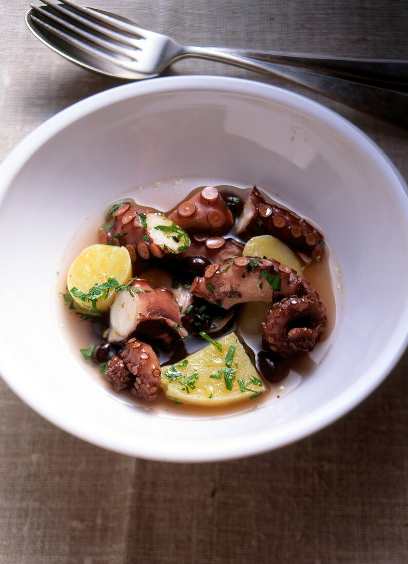 Potato and squid salad in bowl