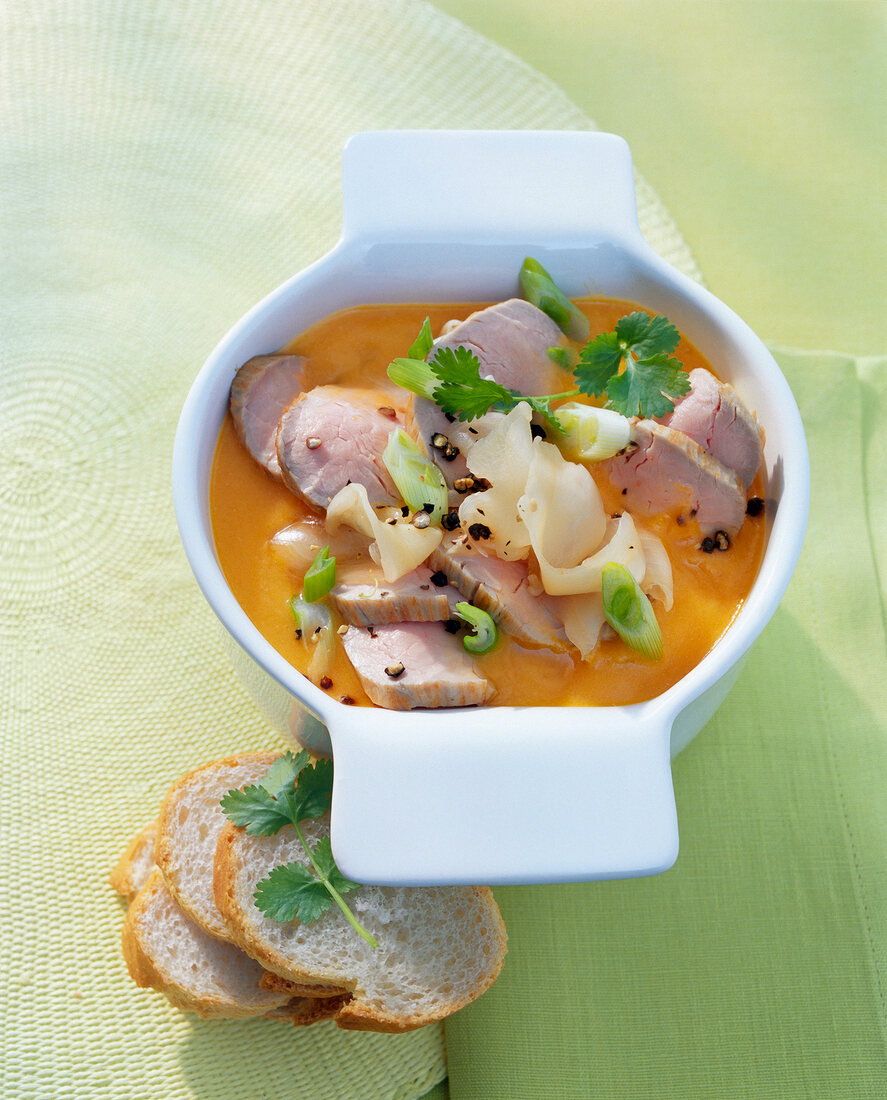 Carrot and ginger soup with pork in soup cup