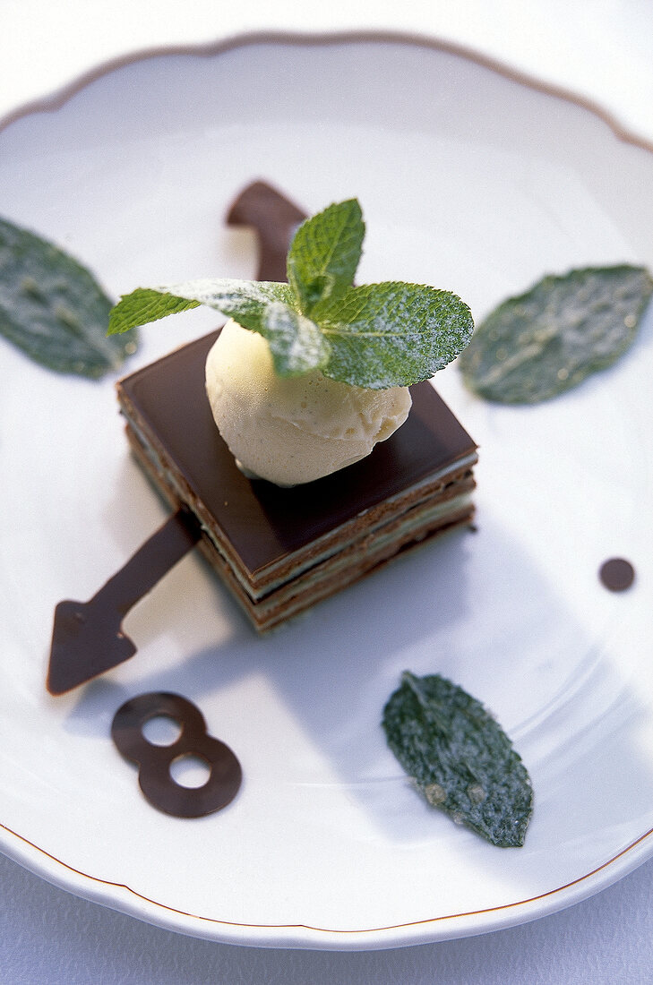 Close-up of dessert with clock designs garnished with mint on plate