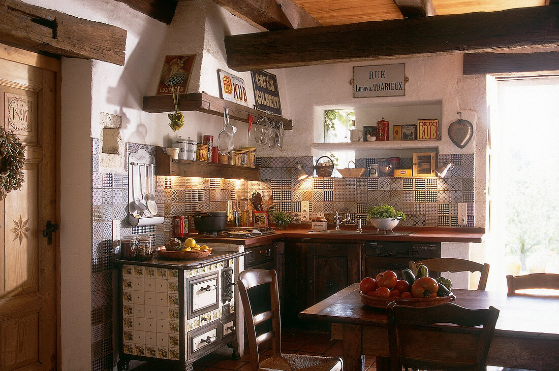Antique kitchen with old stove and antique tiles in South of France