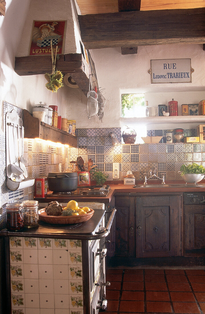 Antique kitchen with old stove and antique tiles in South of France