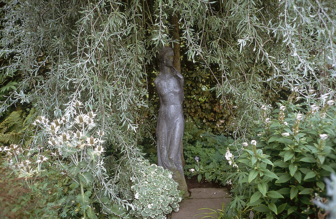Statue under the tree at Sissinghurst Castle Garden, UK