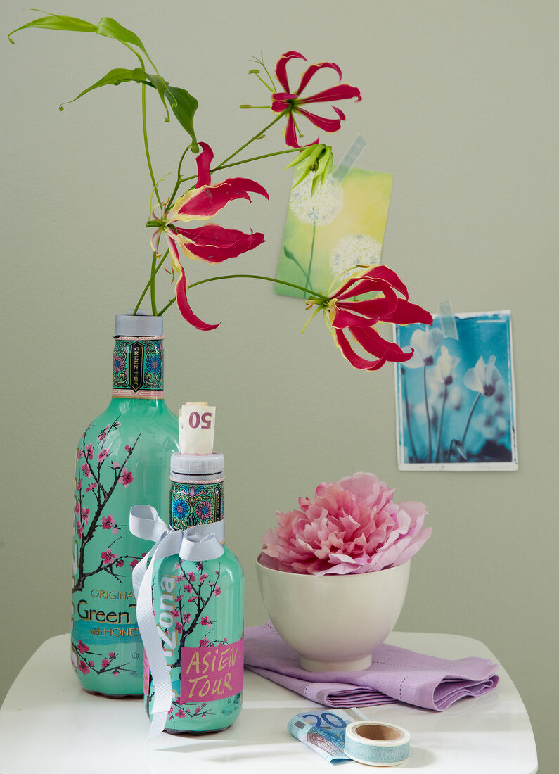 Oriental tea bottles as vases and a money box