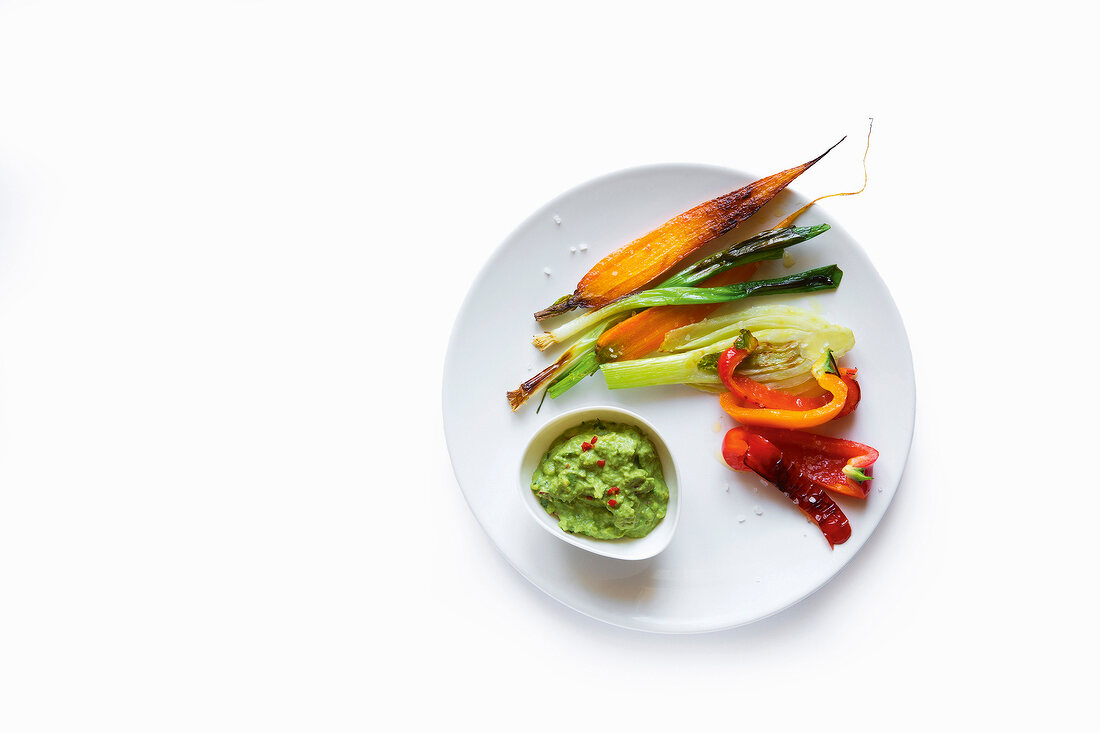 Roasted vegetables with matcha dip on plate, copy space
