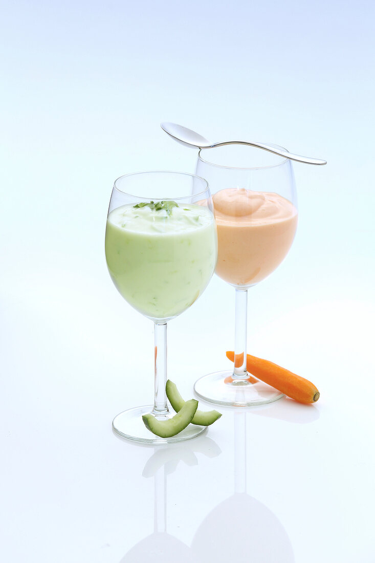 A cucumber and a carrot drink in glasses