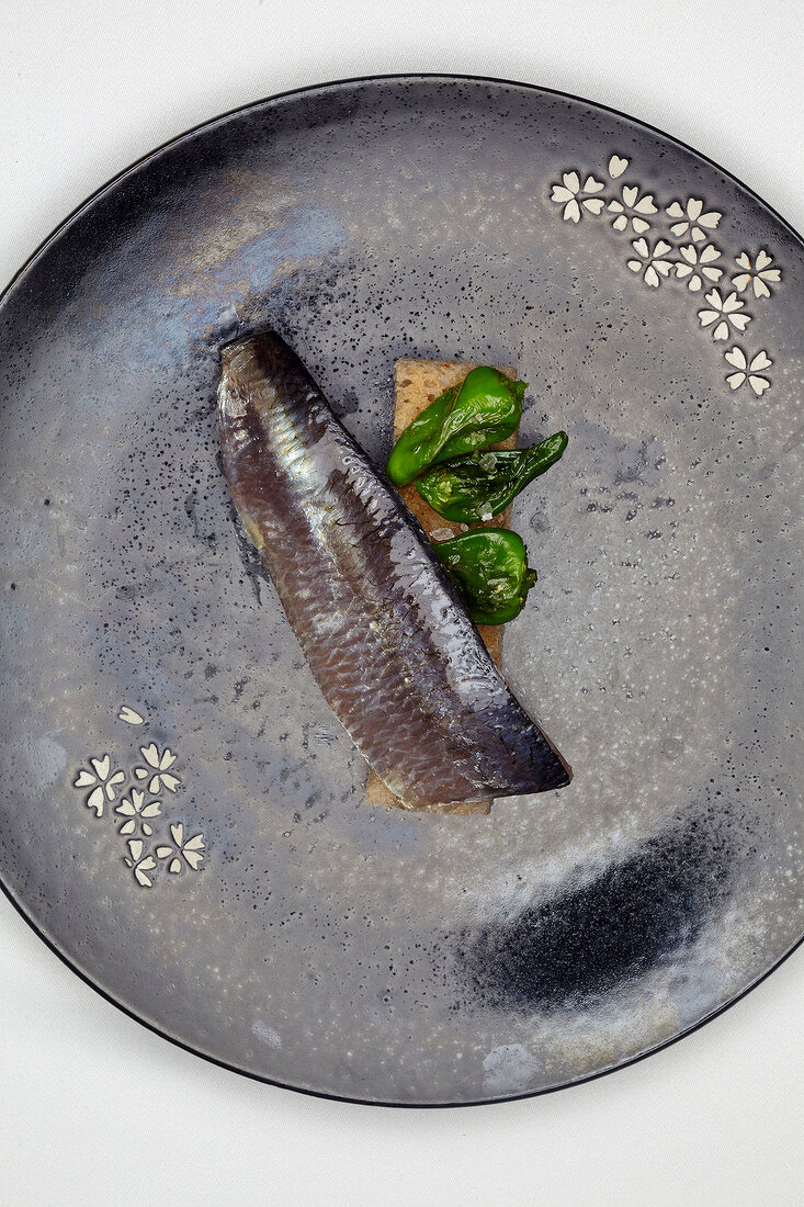 A sardine with pimientos de padron (Galicia, Spain)