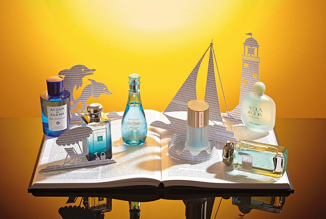 Various perfume bottles against a yellow background