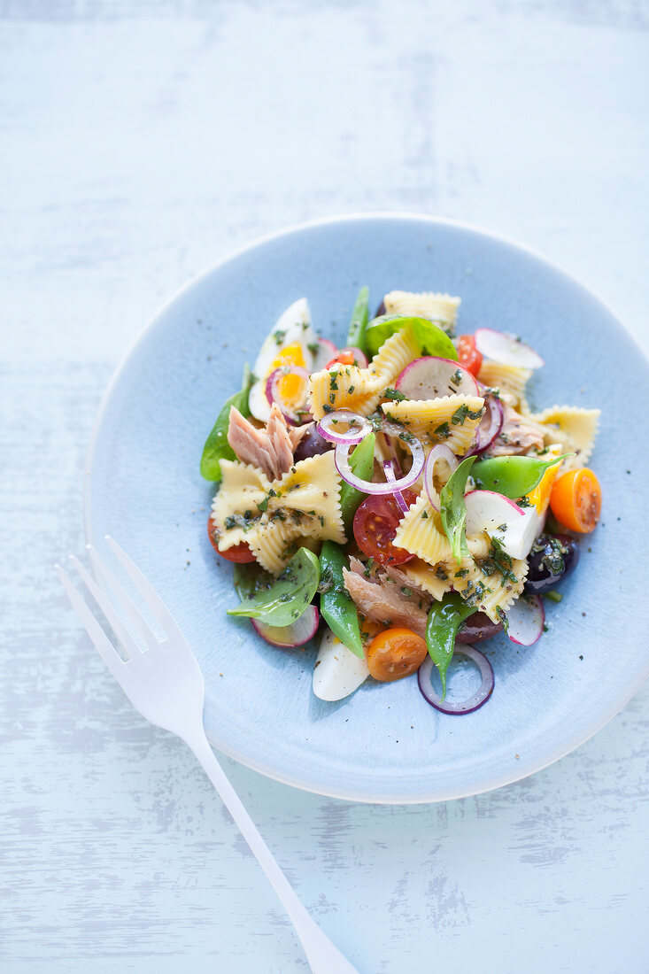 Mediterranean pasta salad with farfalle, tuna fish, egg and vegetables