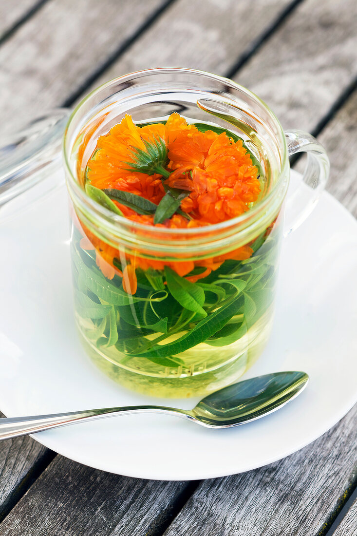 Herbal tea with marigolds and verbena in a tea glass