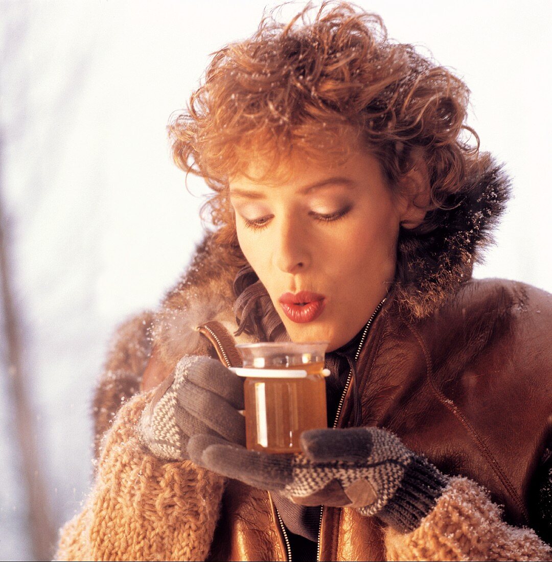 Woman Drinking Hot Tea; Snow
