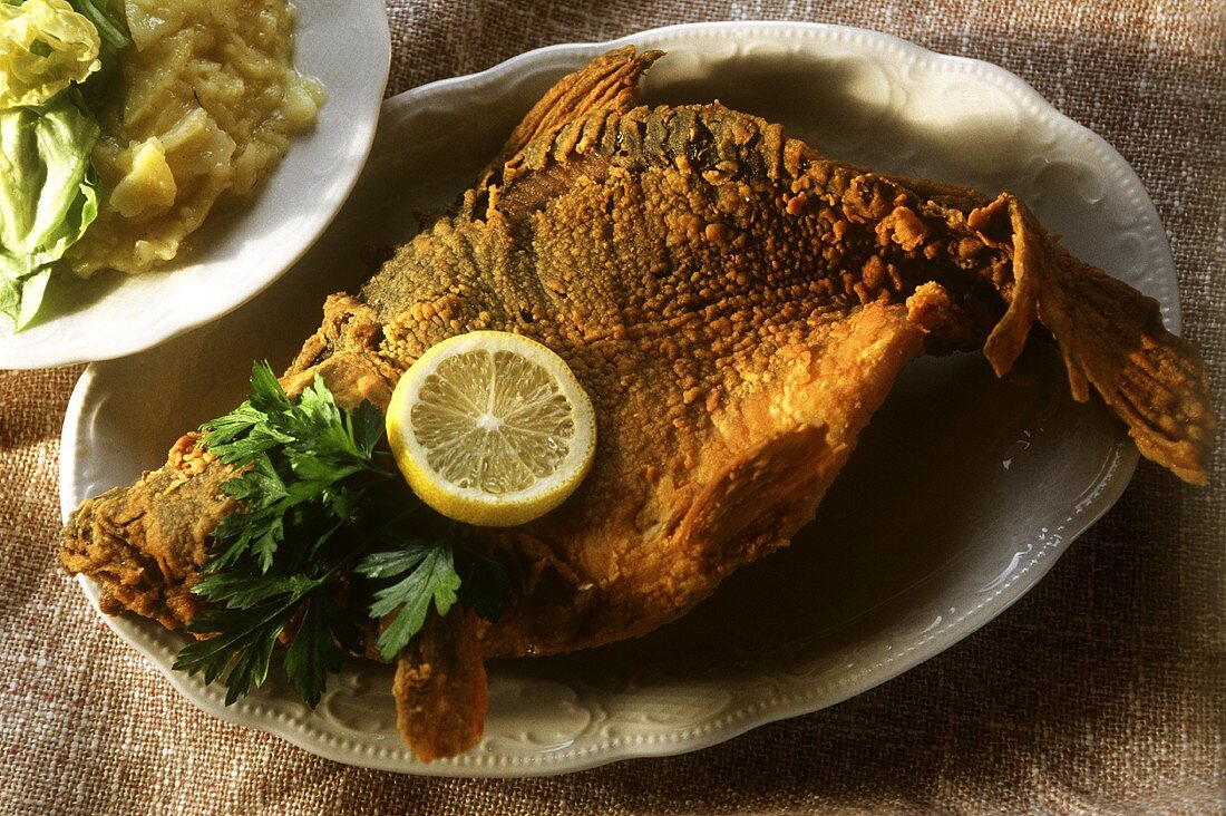 Baked carp with potato salad