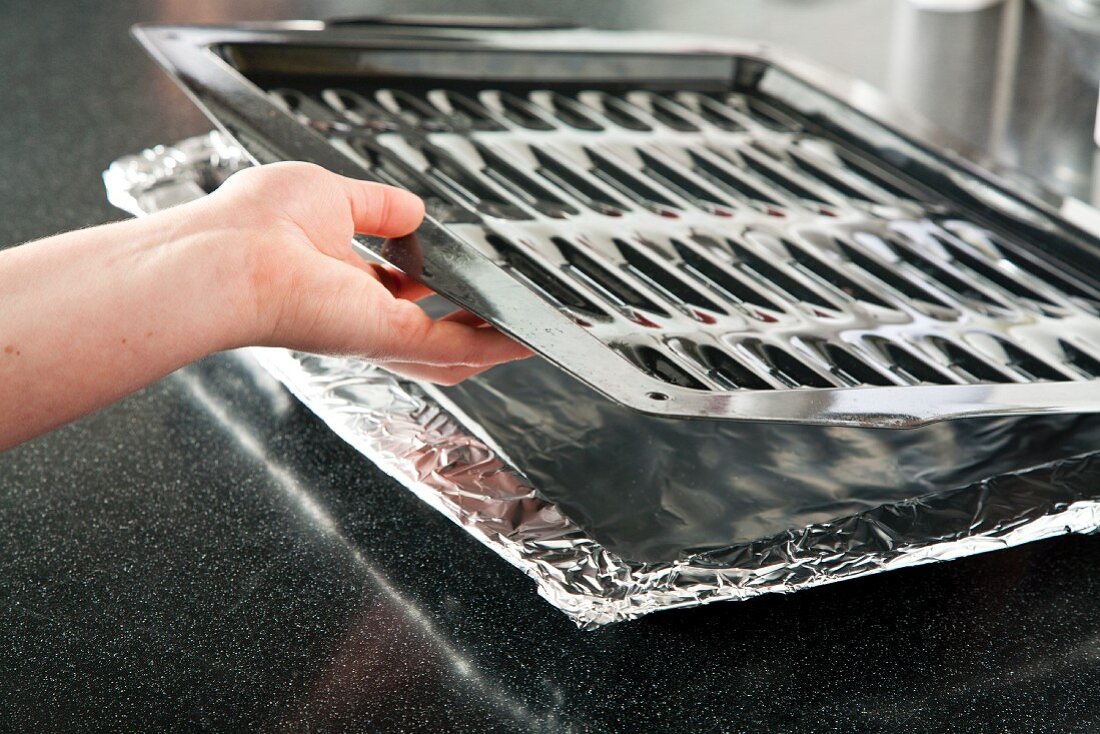 Placing a Broiler Pan on a Foil Lined Pan