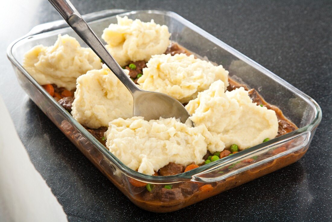 Spooning Mashed Potato Topping onto Shepherds Pie