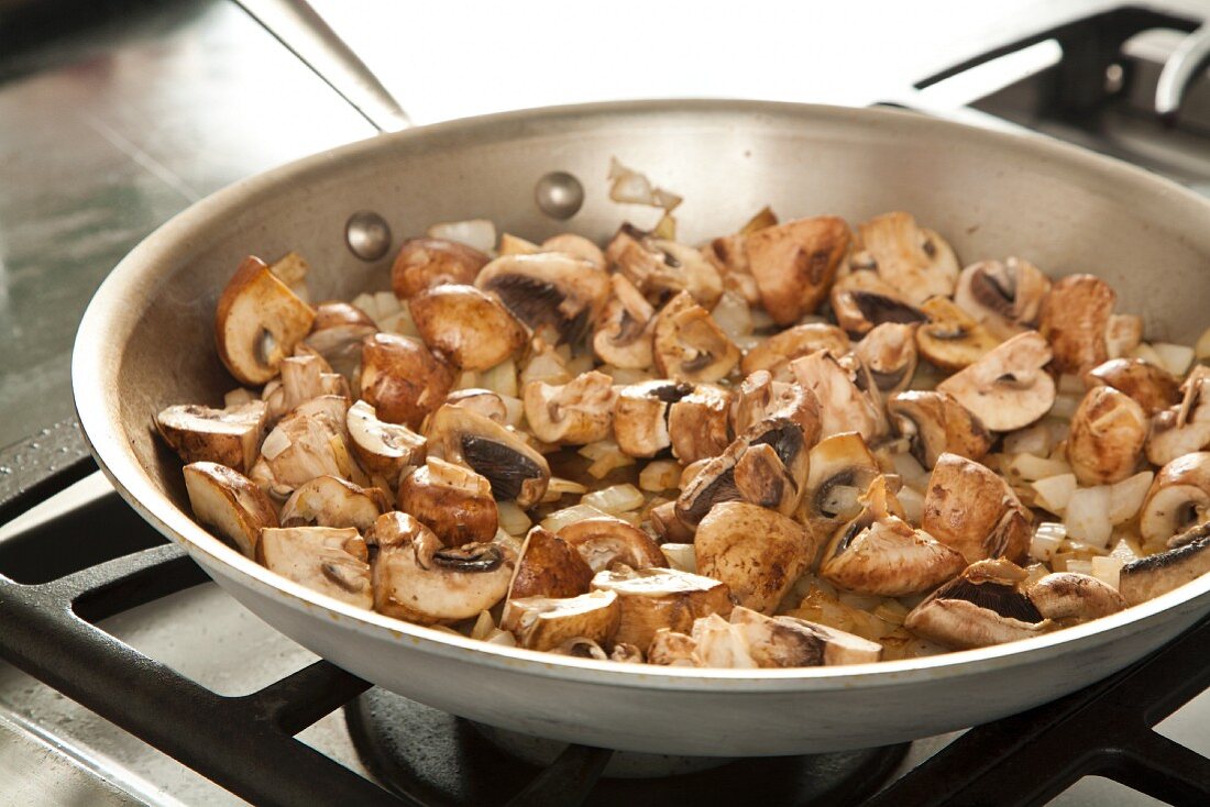 Mushrooms and Onions Cooking in a Skillet